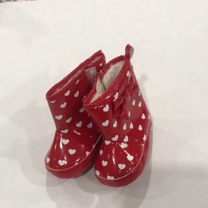 Infant rain booties. Red with white hearts. Open close with side access Velcro
